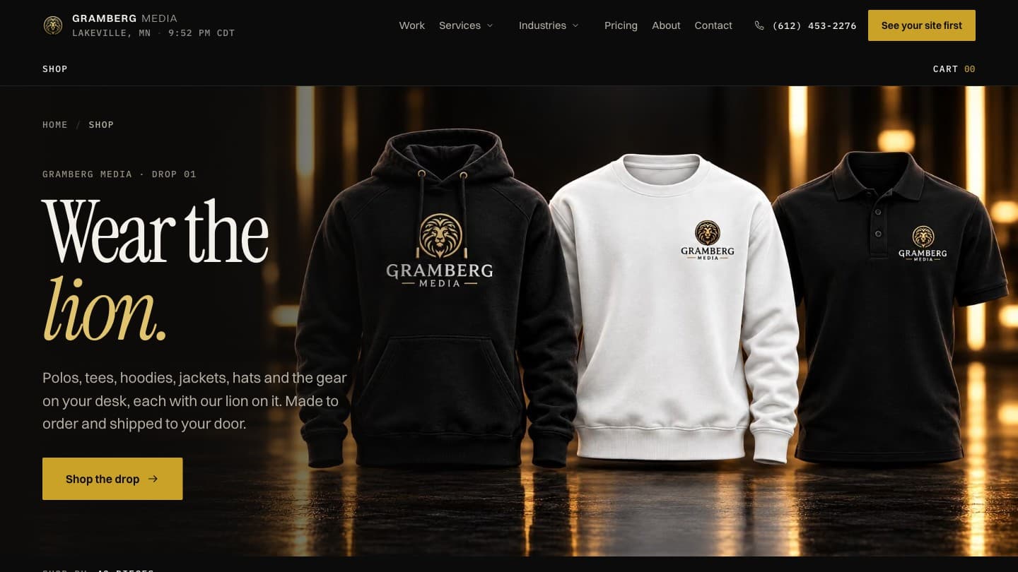 The Gramberg Media shop: the headline Wear the lion. beside a black hoodie, a white crewneck and a black polo, each with the gold lion logo